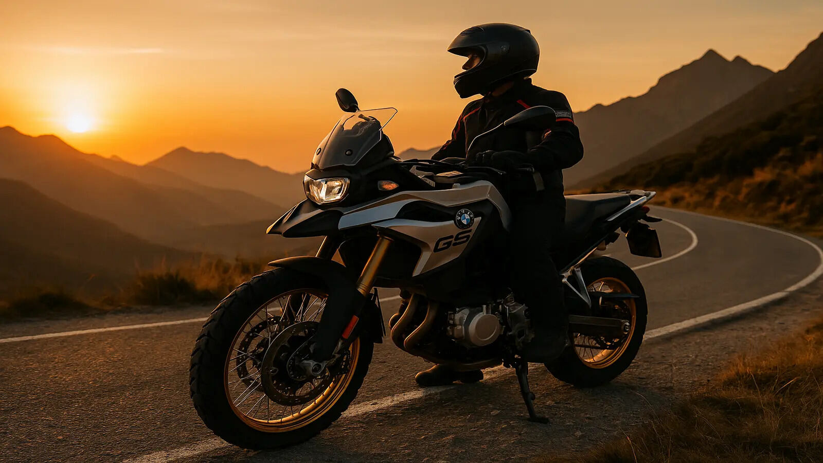 BMW F 450 GS adventure bike on a mountain road during golden hour